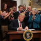 President Donald Trump signs an executive order to loosen restrictions on the Affordable Care Act in the Roosevelt Room of the White House in Washington, D.C., on Oct. 12, 2017. (Alex Wong/Getty Images)
